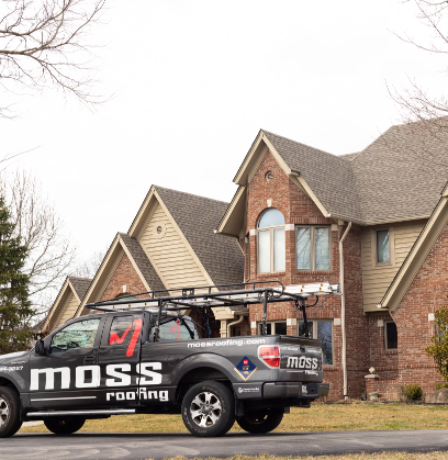 Moss Roofing truck outside of brick and vinyl siding house in Indianpolis with a recent roof replacement courtesy of Moss Roofing.