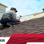 photo of workers on a residential roof repairing shingles