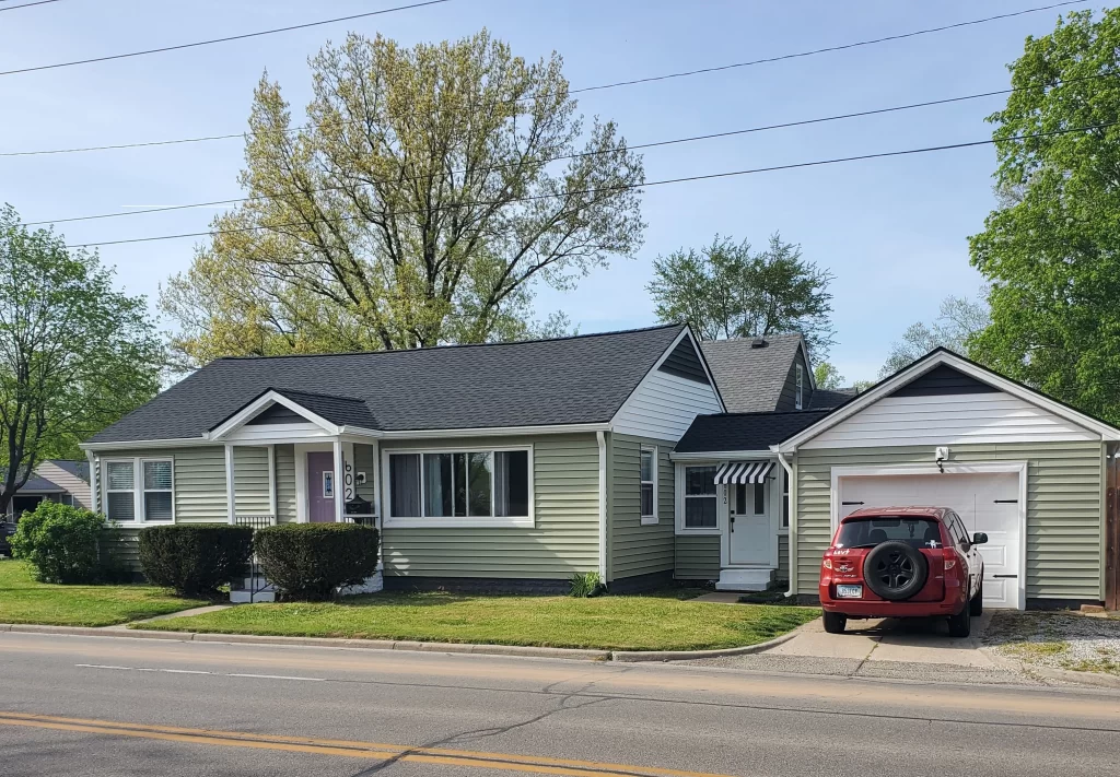 Grey shngles on green home