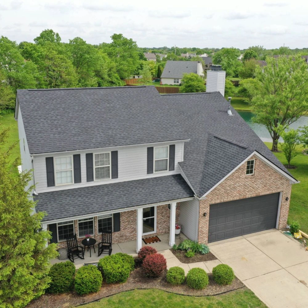 Aerial view of residential home with gray asphalt shingle roof showing proper installation and coverage