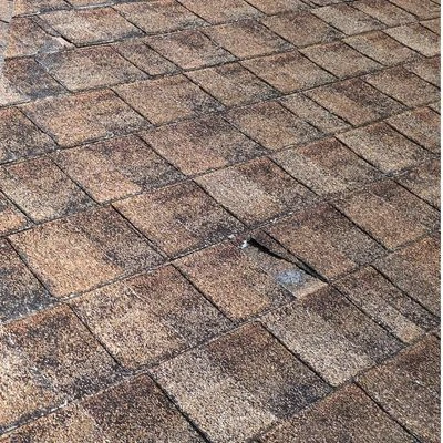 Asphalt roof with missing and torn shingles in Indianapolis