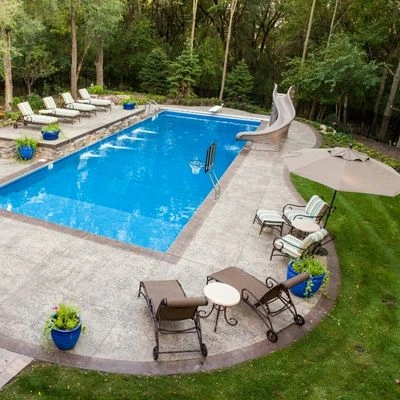 Backyard pool surrounded by decorative concrete for a residential home in Indianapolis.