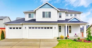 Modern home with new shingle roofing and fresh concrete driveway to improve curb appeal.