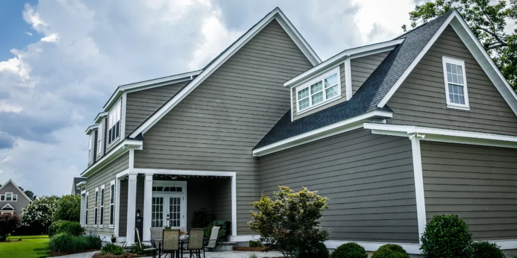 Gray home with James Hardie fiber cement siding and white trim under a cloudy sky