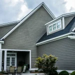 Gray home with James Hardie fiber cement siding and white trim under a cloudy sky