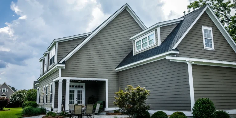 Gray home with James Hardie fiber cement siding and white trim under a cloudy sky