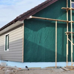 Siding installation on the side of a home with scaffolding.