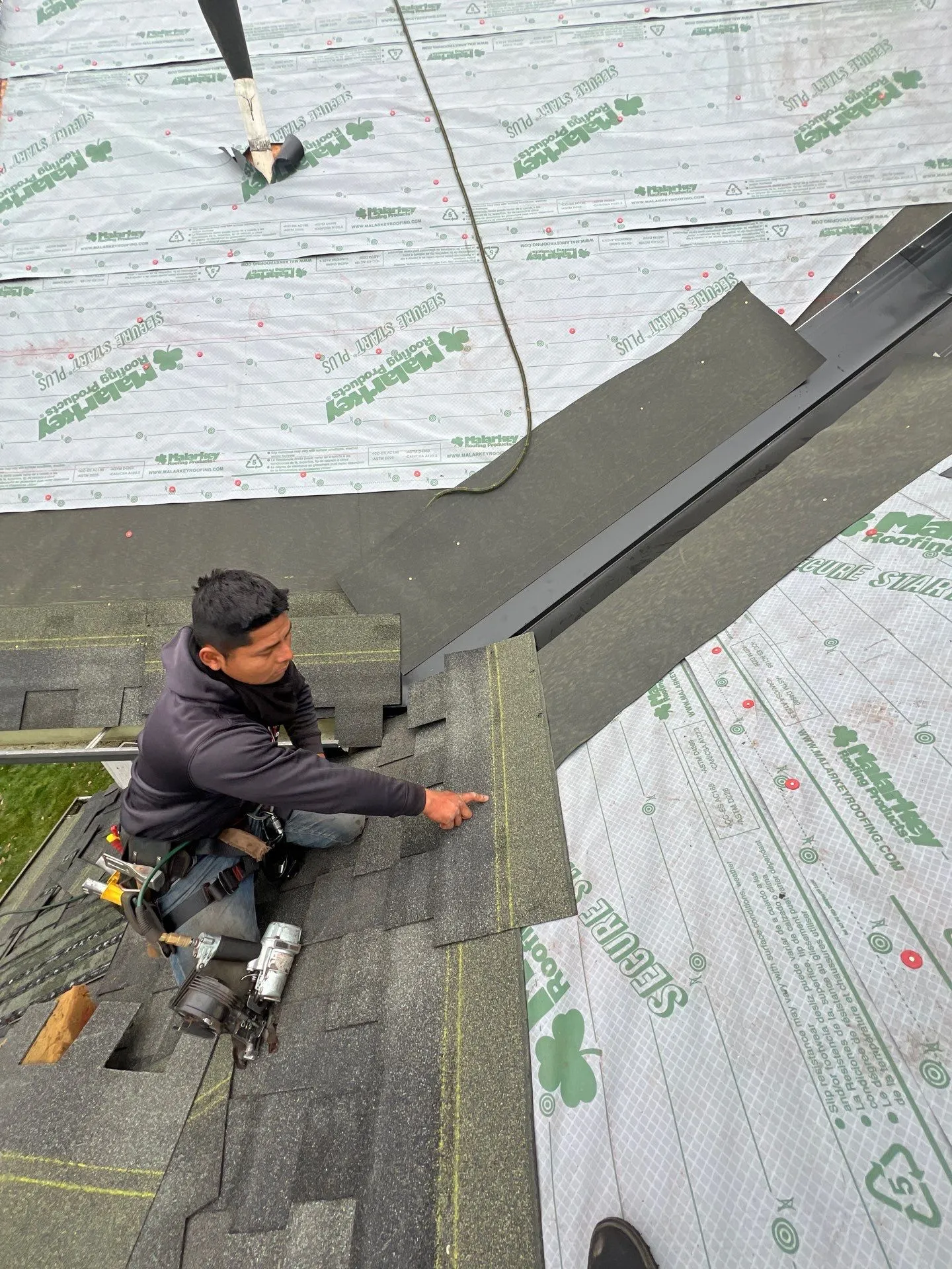Moss Roofing expert installing shingles