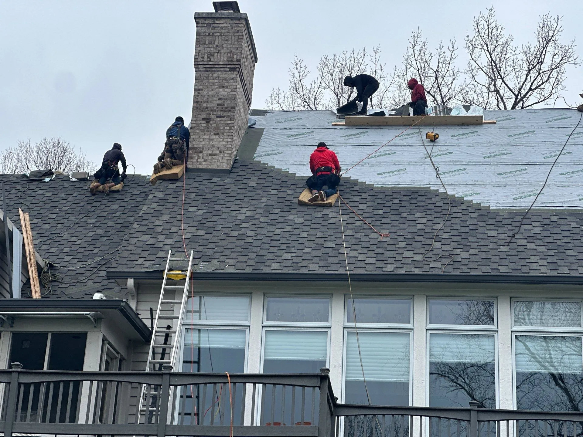 Moss Roofing team on Indianapolis home performing a roof replacement