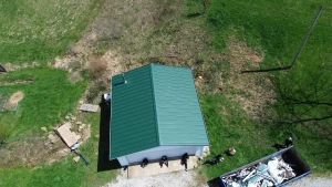 ariel view of barn with new green metal roof installation
