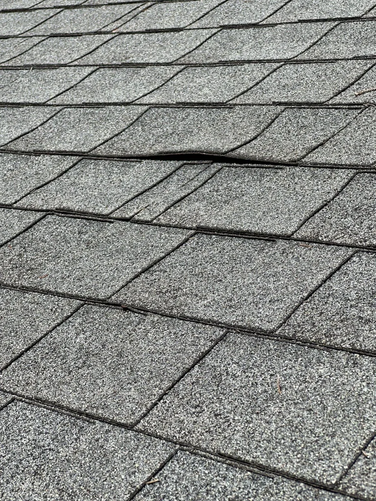 Shingles lifting from roof decking