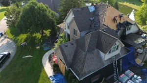 roofing team starting to perform tear off of old roof