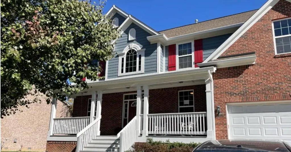 Home with a full siding replacement and a beautiful blue exterior.